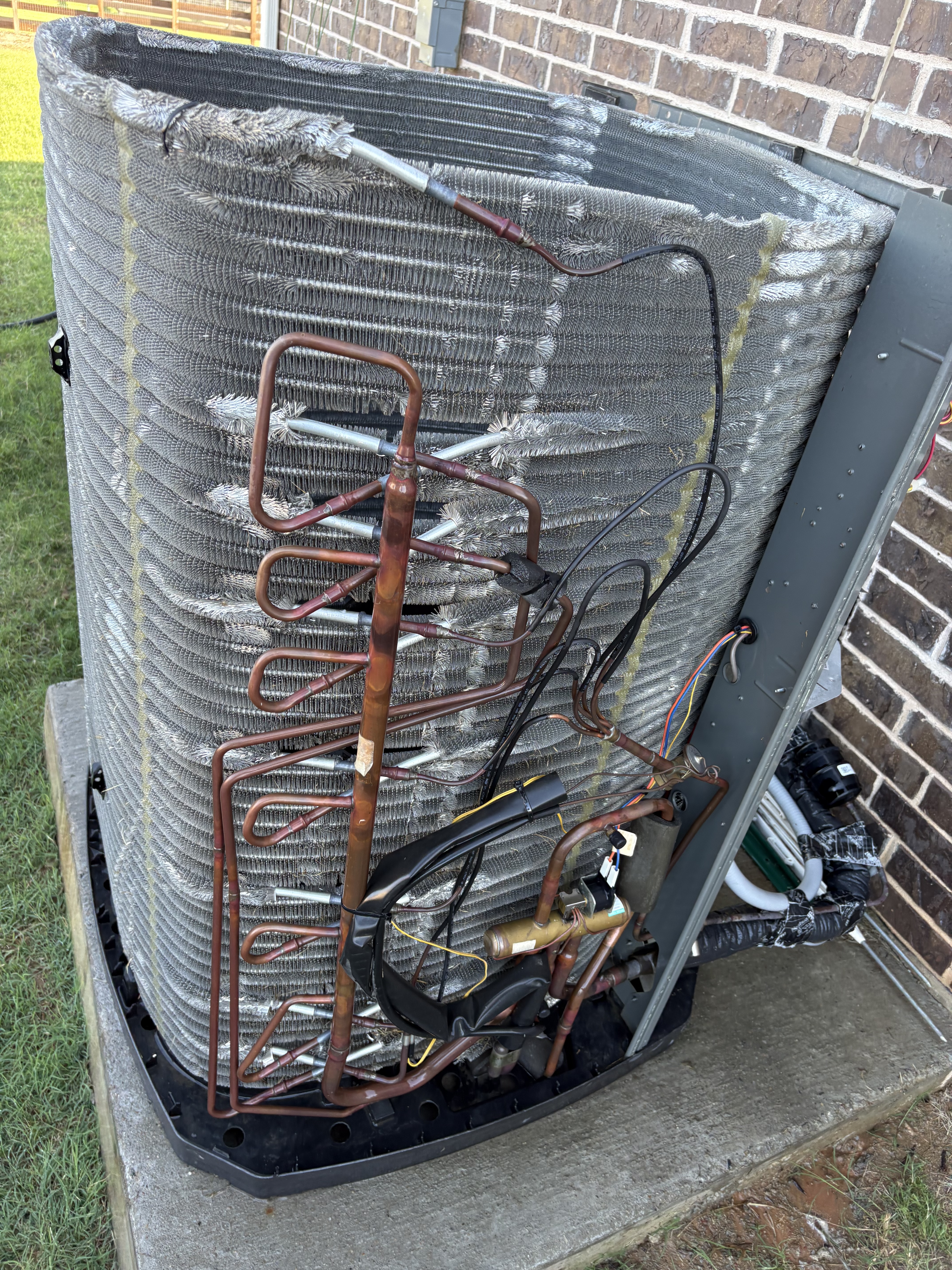 Opened AC condenser unit showing internal components